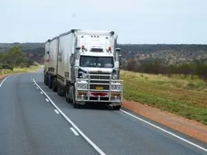 A truck pulling multiple trailers behind it