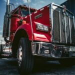 A low angle view of a red tractor trailer