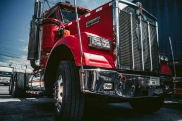 A low angle view of a red tractor trailer